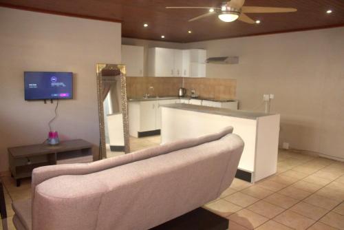 a living room with a couch and a mirror at Hephzibah Manor in Alberton