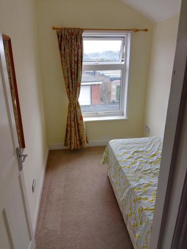 a bedroom with a bed and a window at Nature and beach in Lowestoft