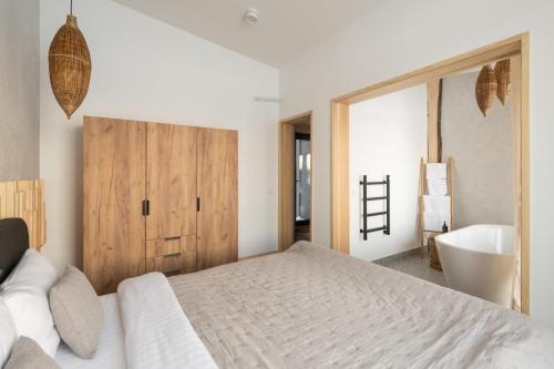 a bedroom with a bed and a tub and a sink at Характер парк in Hatne
