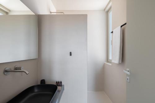a bathroom with a sink and a mirror at Clementina Hill in Naousa