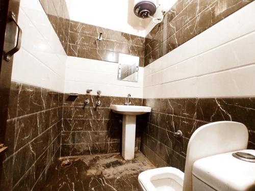 a bathroom with a sink and a toilet at ML HOMESTAYS - For Family, Students, Parents, Couples in Phagwāra