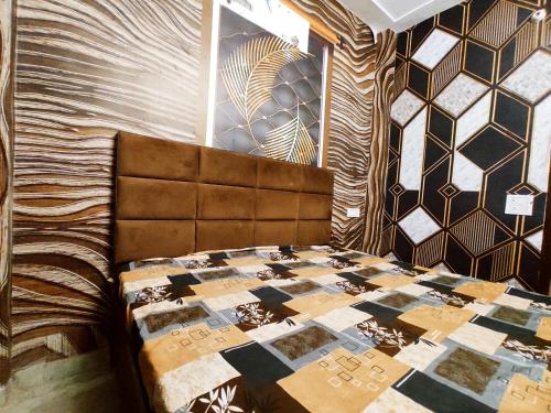 a bedroom with a bed with a quilt on it at ML HOMESTAYS - For Family, Students, Parents, Couples in Phagwāra