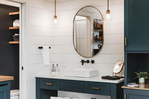 a bathroom with a sink and a mirror at Luxury tiny house with hot tub and private deck! in Guntersville