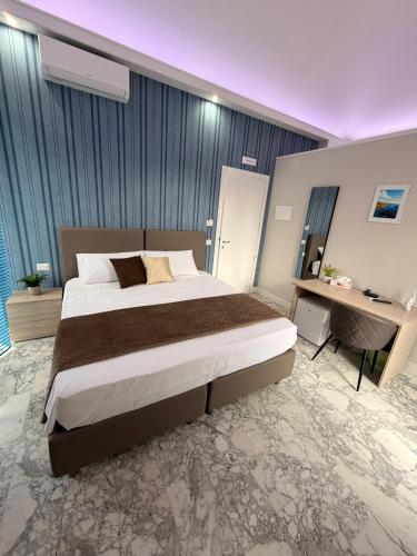 a bedroom with a large bed and a desk at Saraceno House G&P in Adrano