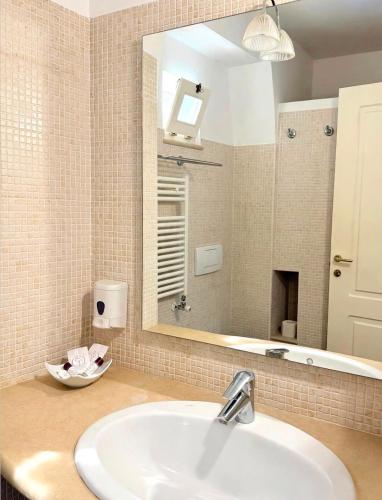 a bathroom with a sink and a mirror at Residence Del Casalnuovo in Matera