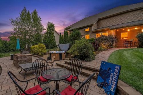 a patio with a table and chairs and a grill at The Blue Crown Manor at Concord Estates in Concord