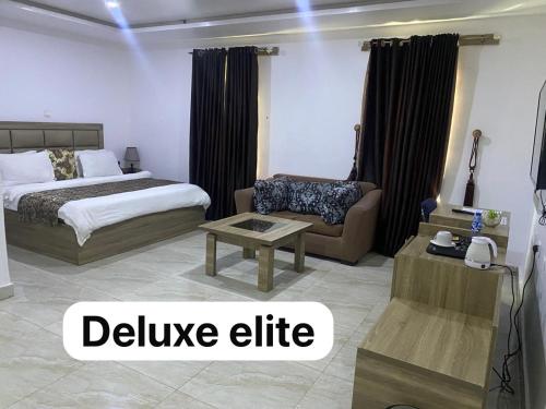 a hotel room with a bed and a couch at Bgl suites in Barakin Akawo