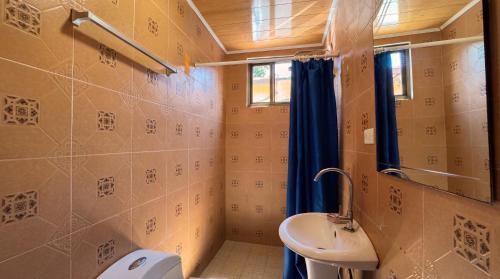 a small bathroom with a sink and a toilet at Roxys Inn in Boca Chica