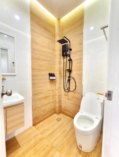 a bathroom with a toilet and a sink at The Courtyard Heritage Pool Villa Udonthani in Udon Thani