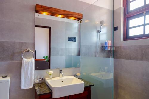 a bathroom with a sink and a mirror at Kasitha Ocean View Villa - Matara Beach Road in Matara