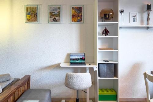 a room with a desk with a laptop computer on it at Am Silberbergblick in Bodenmais