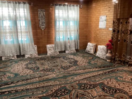 a room with a large rug on the floor at Visiting Villa in Srinagar