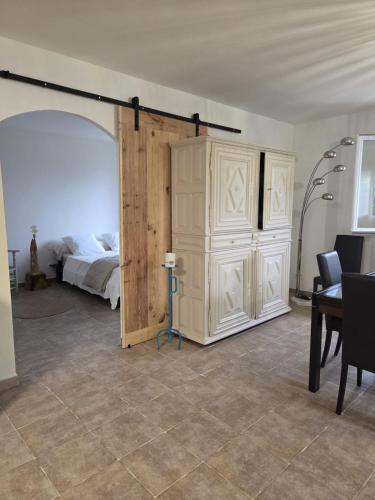 a bedroom with a bed and a large wooden door at A Casa POGGIOLI in Rogliano