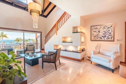 a living room with a view of the ocean at Gorgeous PH at Puerto Bahia in Santa Bárbara de Samaná