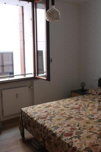 a bedroom with a bed and a window at Bonbon in Treviso