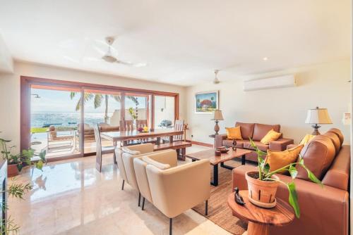 a living room with a couch and a table at 3BR Beachfront townhouse at Puerto Bahia in Santa Bárbara de Samaná