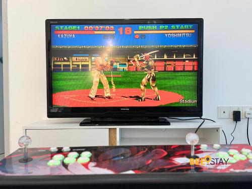 a television screen showing a baseball game at Desaru Arcadia Double Storey House 11-16 Pax 5 Mins to Desaru Beach in Bandar Penawar