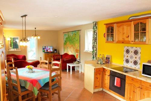 a kitchen and living room with a table and a dining room at Dat Uhlenhus in Bohlsen