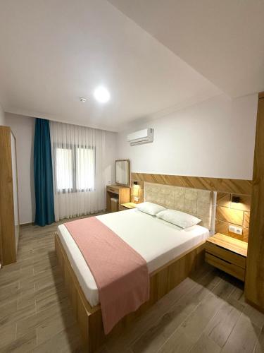a bedroom with a large bed in a room at ÇAMLIK APART in Ayvalık