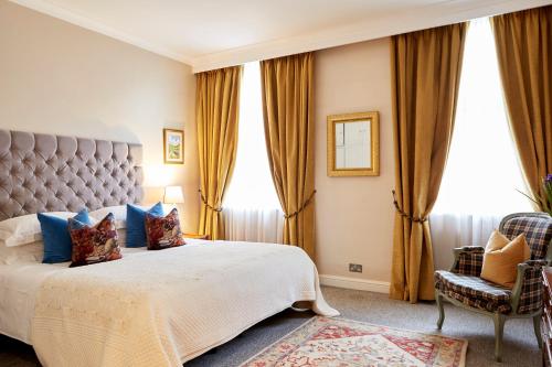 a bedroom with a large bed with a large window at 9 Hertford Street Mayfair in London