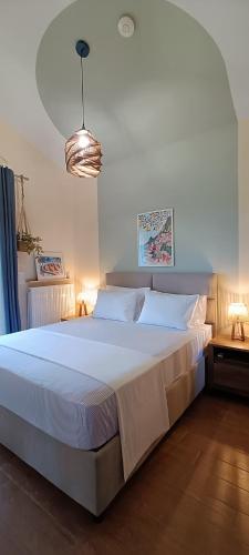 a bedroom with a large white bed in a room at Country Nest in Messini