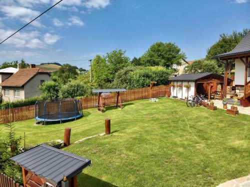 a yard with a playground and a fence at Chalupa Na Bačáku in Frýdek-Místek