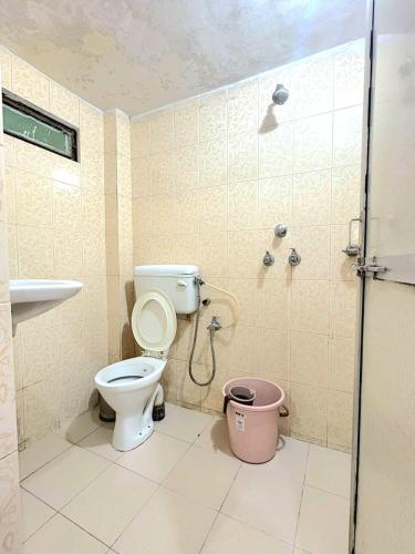 a bathroom with a shower and a toilet and a sink at Zipcode Kashi in Varanasi