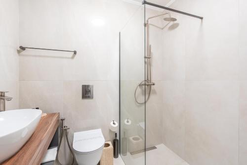 a bathroom with a shower and a toilet and a sink at Hotel Bulevar Mostar in Mostar