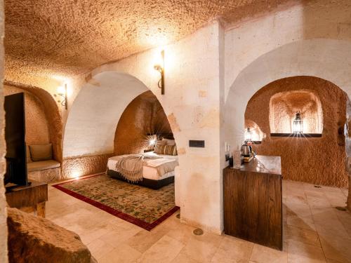 a bedroom with a bed and a tv in a room at Cybele in Cappadocia in Uçhisar