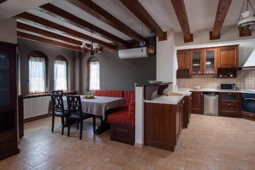 a kitchen with a table and chairs in a room at The Grand Panorama Villa in Nea Moudania