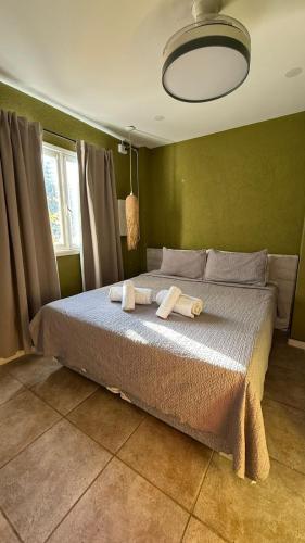 a bedroom with a bed with two towels on it at Mare Hotel Apartment in Mar del Plata