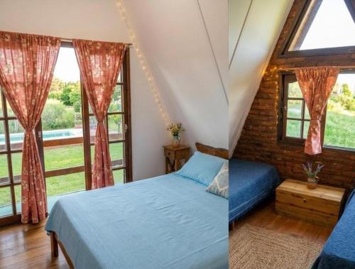 a bedroom with a bed and two windows at Cabañas Don Luis in Valle Hermoso
