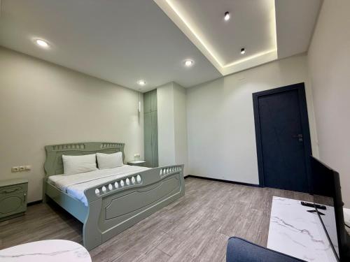 a bedroom with a bed and a mirror and a door at Sevanavanq Inn Hotel in Sevan