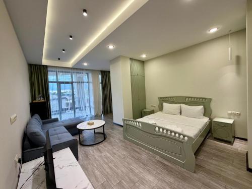 a bedroom with a bed and a couch and a table at Sevanavanq Inn Hotel in Sevan