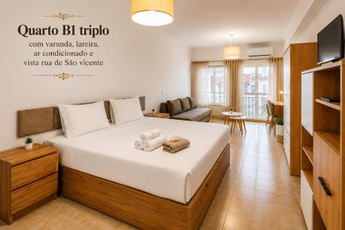 a bedroom with a bed and a living room at Rooms4you 2 in historic center of Braga in Braga