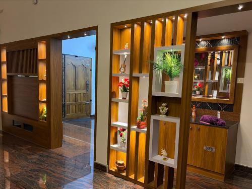 a hallway with doors and shelves with potted plants at Bamivigas Retreat in Kattappana