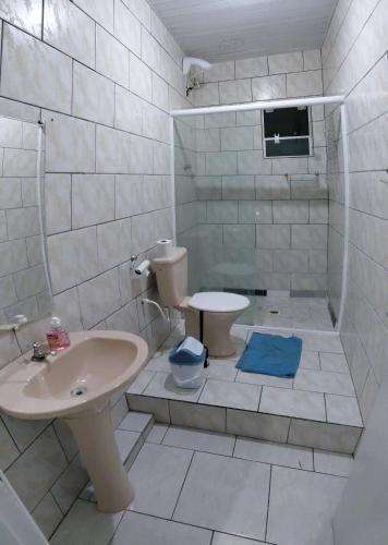a bathroom with a sink and a toilet at Pousada familiar 07 in Rio do Sul