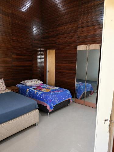 a bedroom with two beds and a mirror at Rancho Nova Car in Ariquemes
