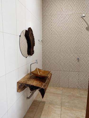 a bathroom with a sink and a shower at Rancho Nova Car in Ariquemes