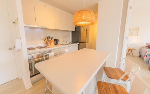 a kitchen with a table and chairs in a room at Oceana Suites Papudo in Papudo
