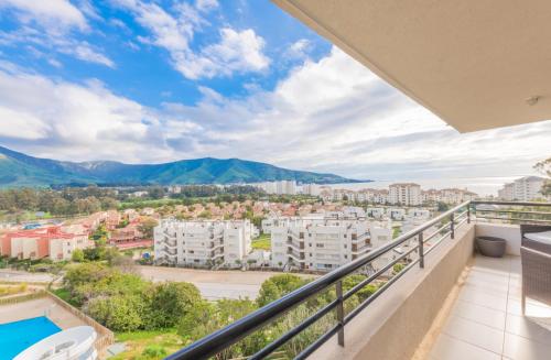a balcony with a view of a city at Oceana Suites Papudo in Papudo