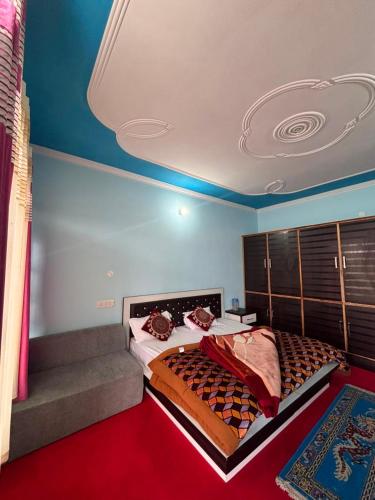 a bedroom with a large bed and a red carpet at Alpine Homestay in Joshīmath