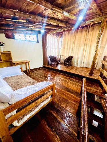 a room with a bed and two chairs in it at Eagle Nest in Namulanda