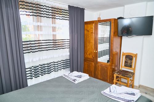 a room with a wine cellar with a television at Вила Якимови in Ribarica