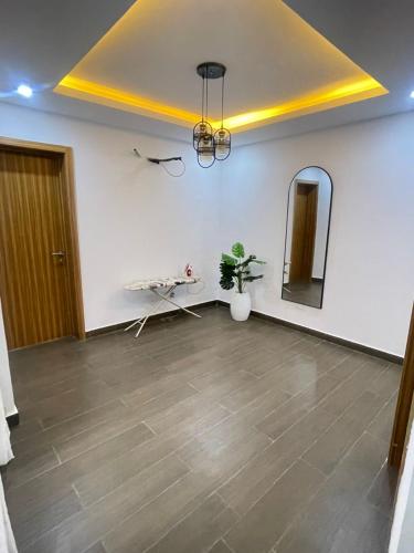 a room with a mirror and a table and a plant at Maisonette near Alpha Beach in Ibeju