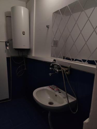 a bathroom with a toilet and a sink and a mirror at Стая за гости При Валко in Belogradchik