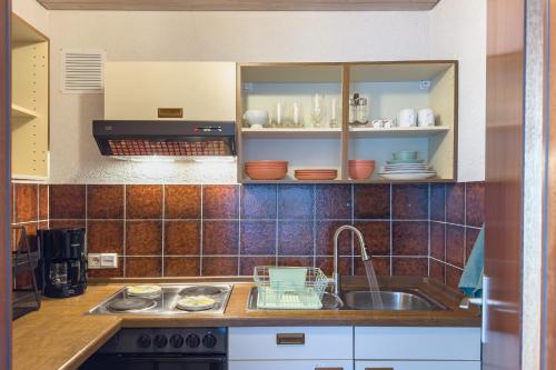 a kitchen with a sink and a counter top at Am Silberbergblick in Bodenmais