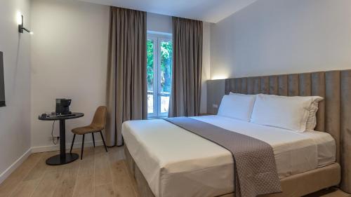 a bedroom with a large bed and a window at GG Spagna Luxury Suites in Rome