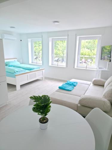 a white living room with a couch and a table at RheinStay Bingen in Bingen am Rhein
