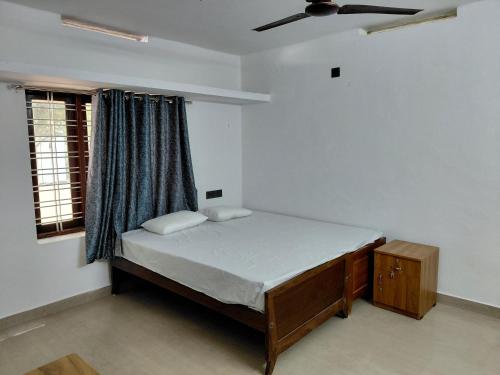 a bedroom with a bed and a window at Casa Inn Homestay in Munnar